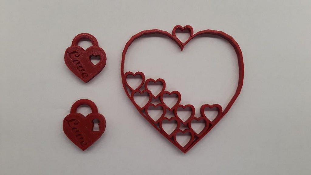 Two heart padlock pendants and a heart ornament