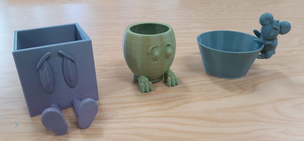 3D printed succulent planters - two of the planters have faces so that the plant will be the hair. The third planter has a Koala hanging off of the bowl.